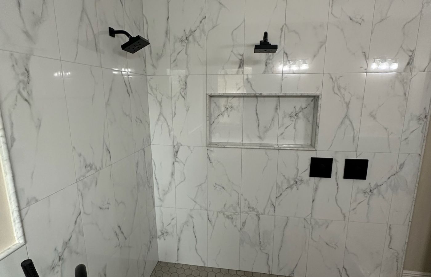 Large-Format Marble Shower with a Recessed Niche.