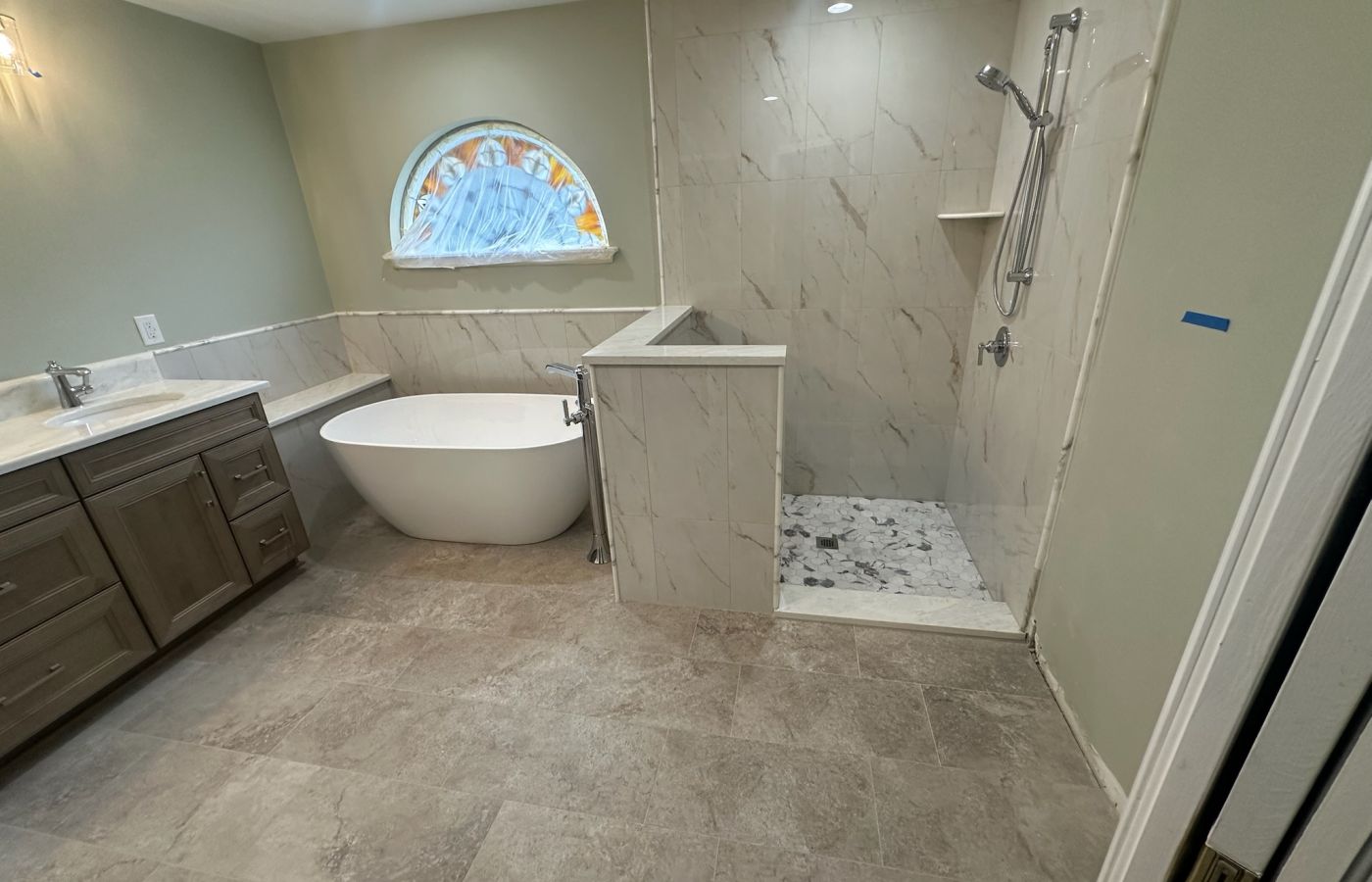 Freestanding Tub and Gray Mosaic Walk-In Shower.