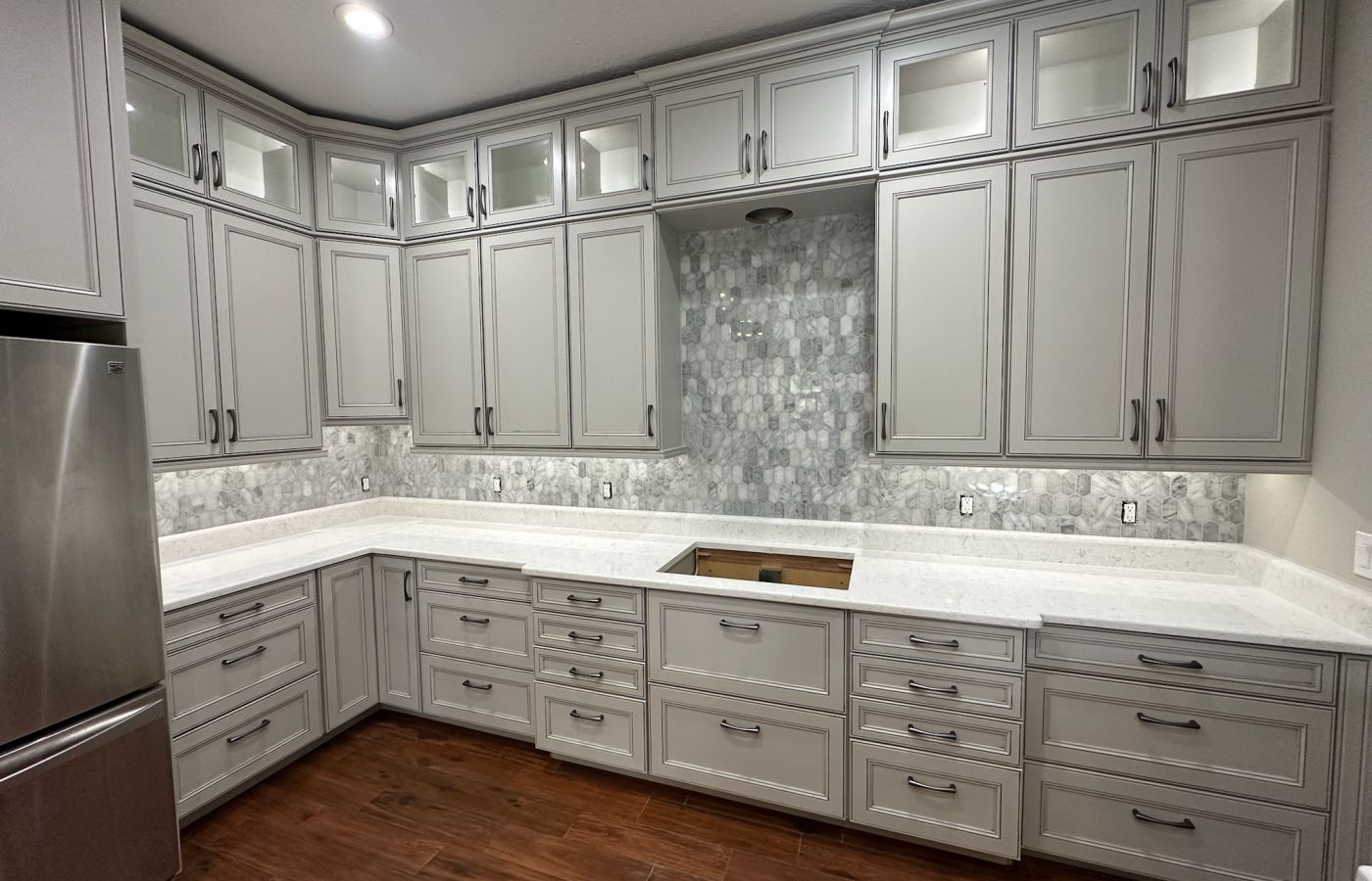 Gray Kitchen Cabinets with a Mosaic Tile Backsplash.