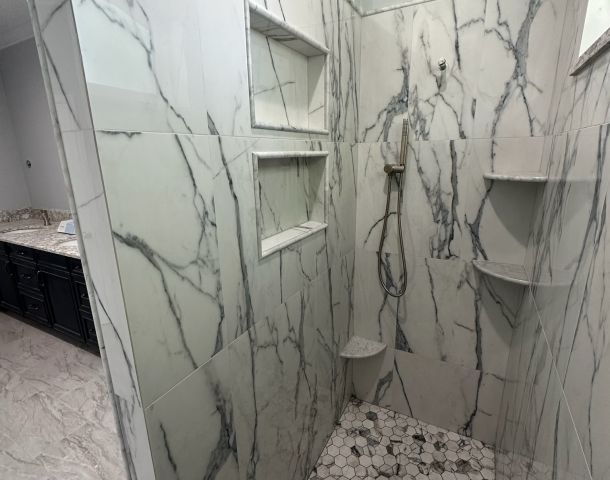 Marble Shower Framed by an Arched Window.