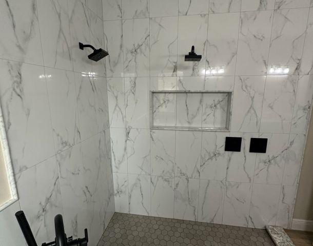 Large-Format Marble Shower with a Recessed Niche.