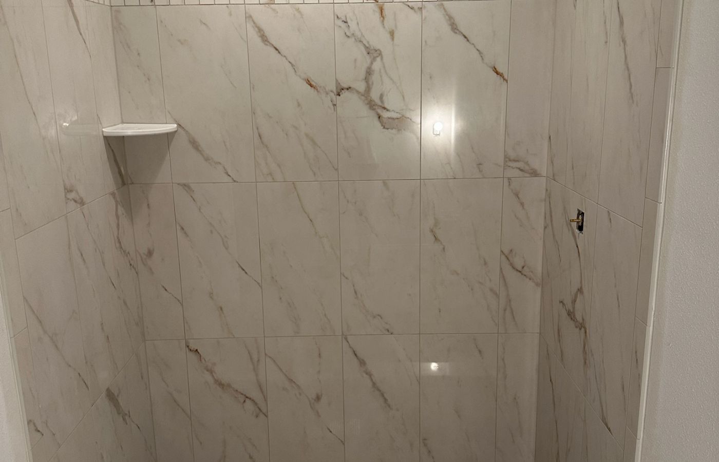 Marble Shower with a Mosaic Accent Stripe.