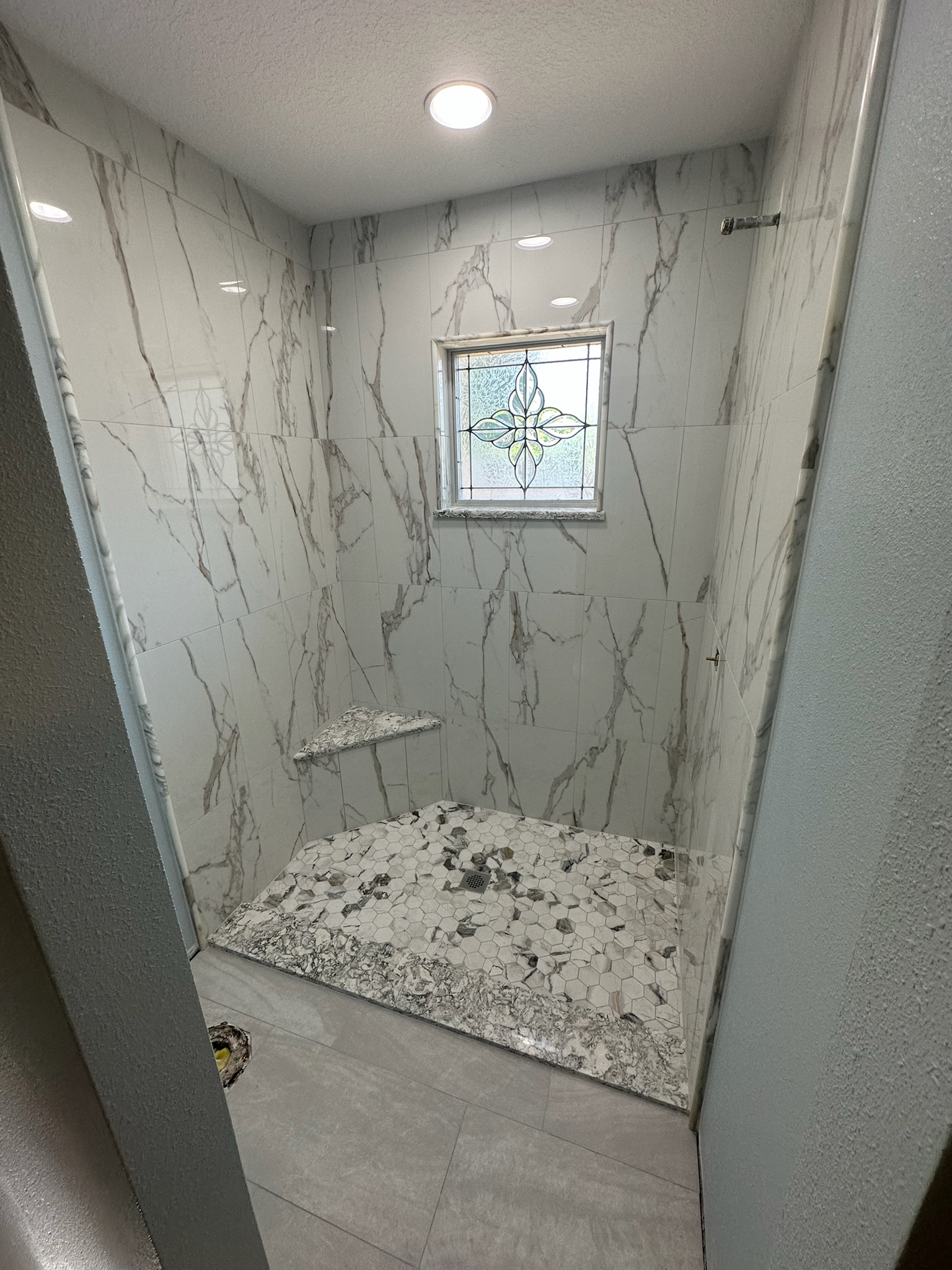 Marble Shower with a Bright Window.