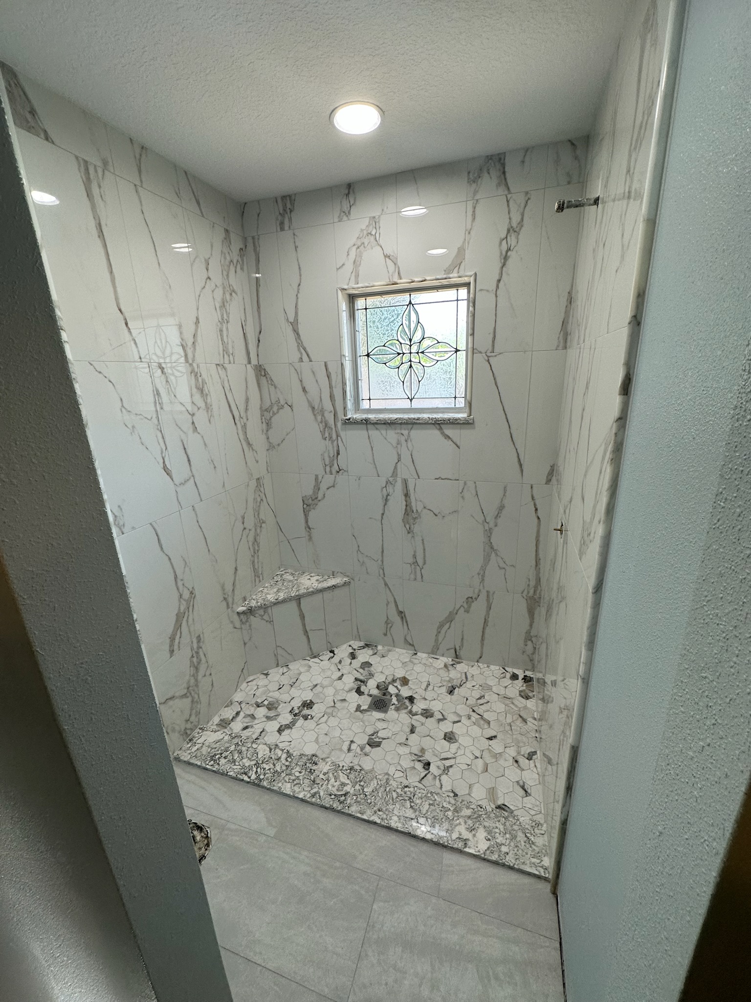 Marble Shower with a Bright Window.
