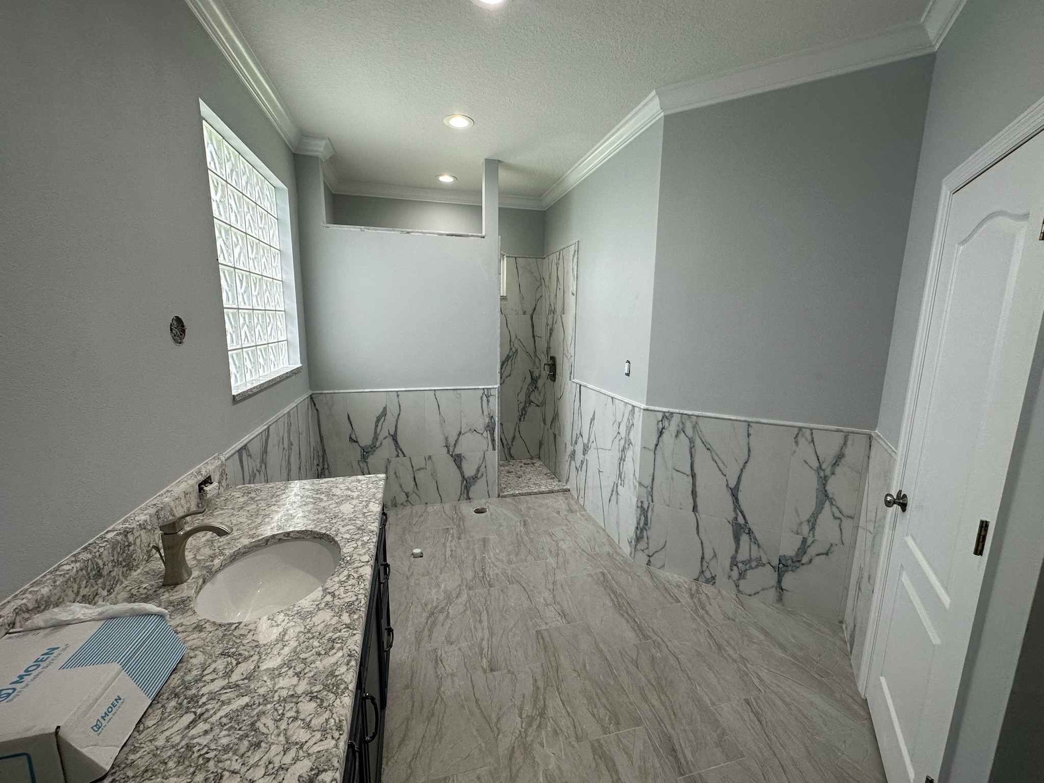 Marble Shower Framed by an Arched Window.
