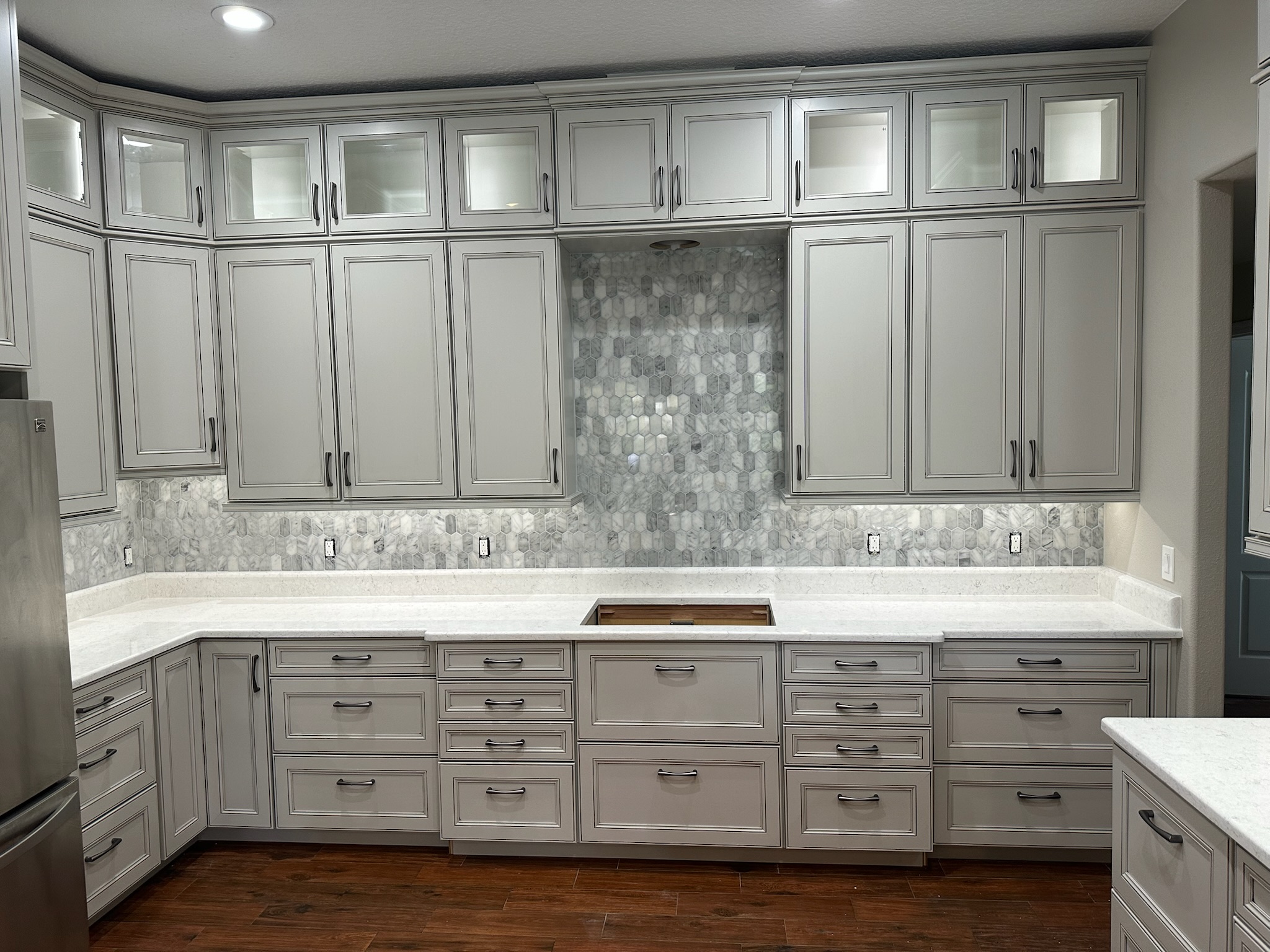 Gray Kitchen Cabinets with a Mosaic Tile Backsplash.