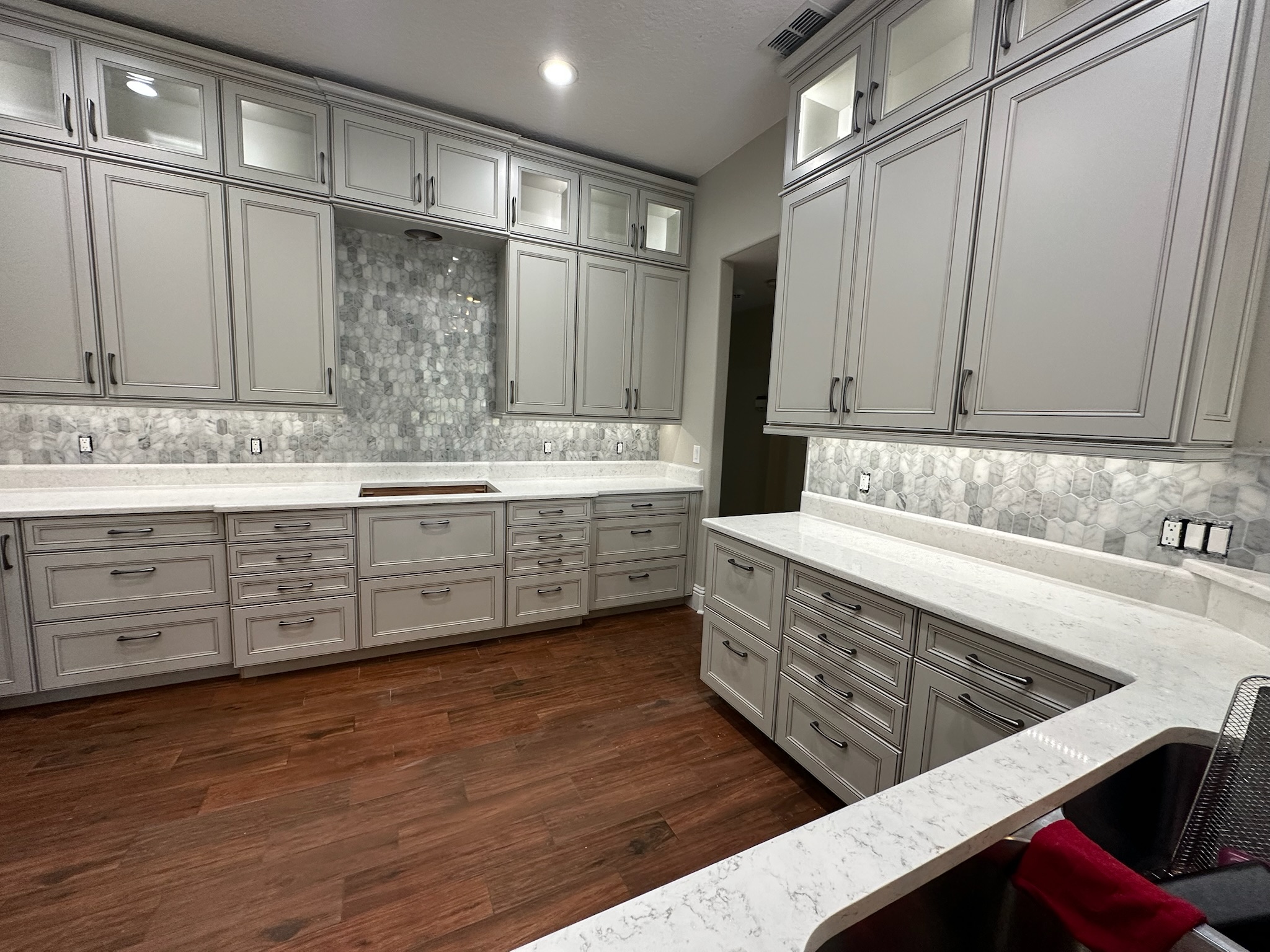 Gray Kitchen Cabinets with a Mosaic Tile Backsplash.