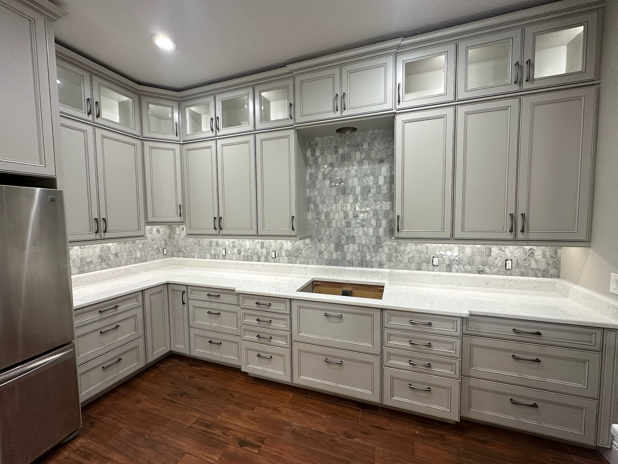 Gray Kitchen Cabinets with a Mosaic Tile Backsplash.