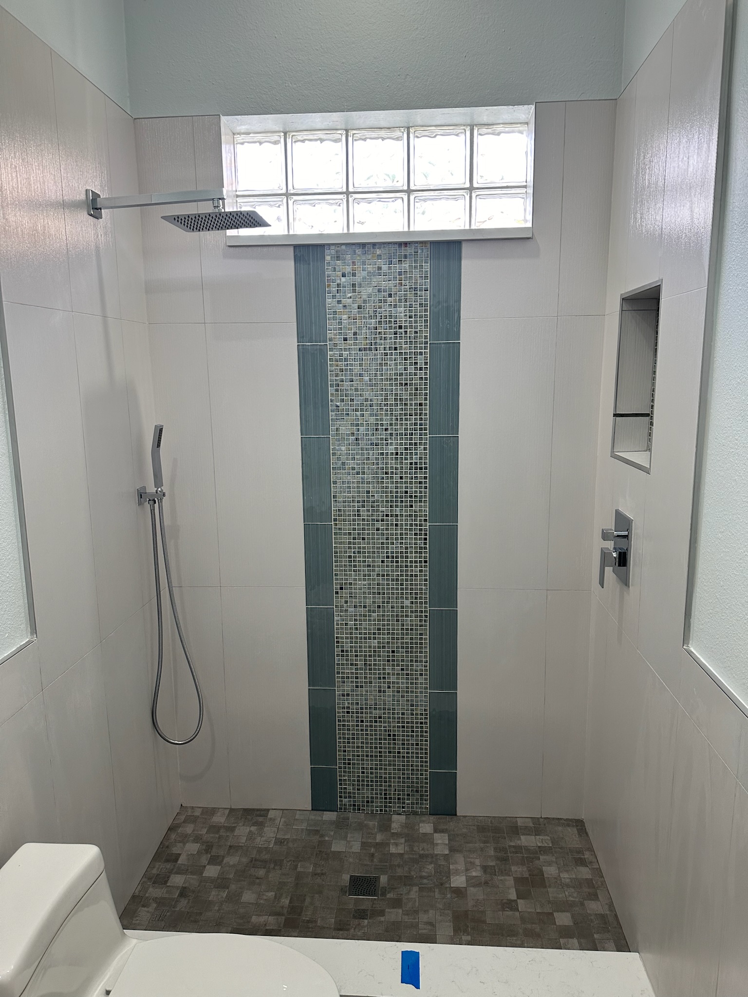 Freestanding Tub and Gray Mosaic Walk-In Shower.