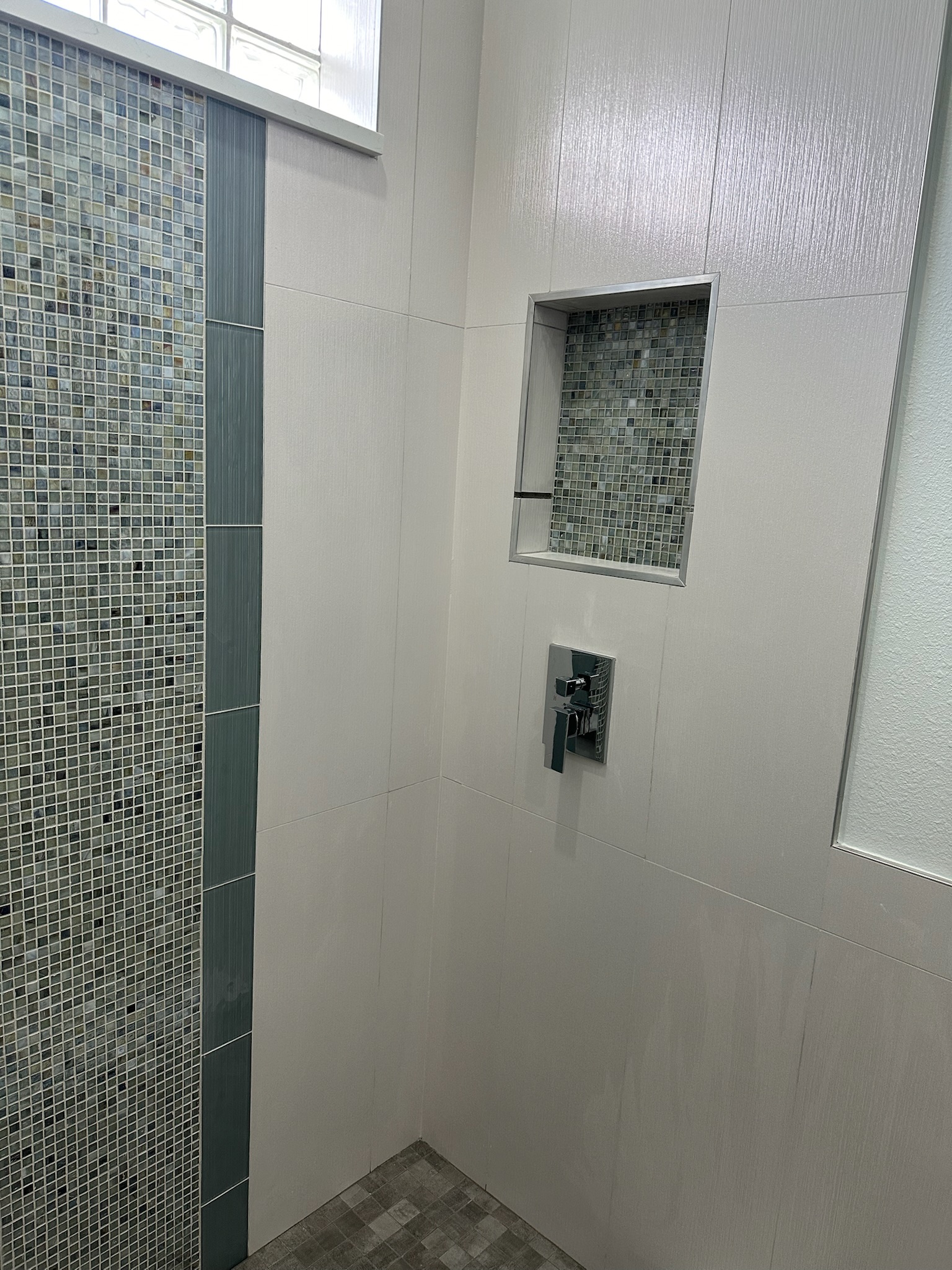 Freestanding Tub and Gray Mosaic Walk-In Shower.