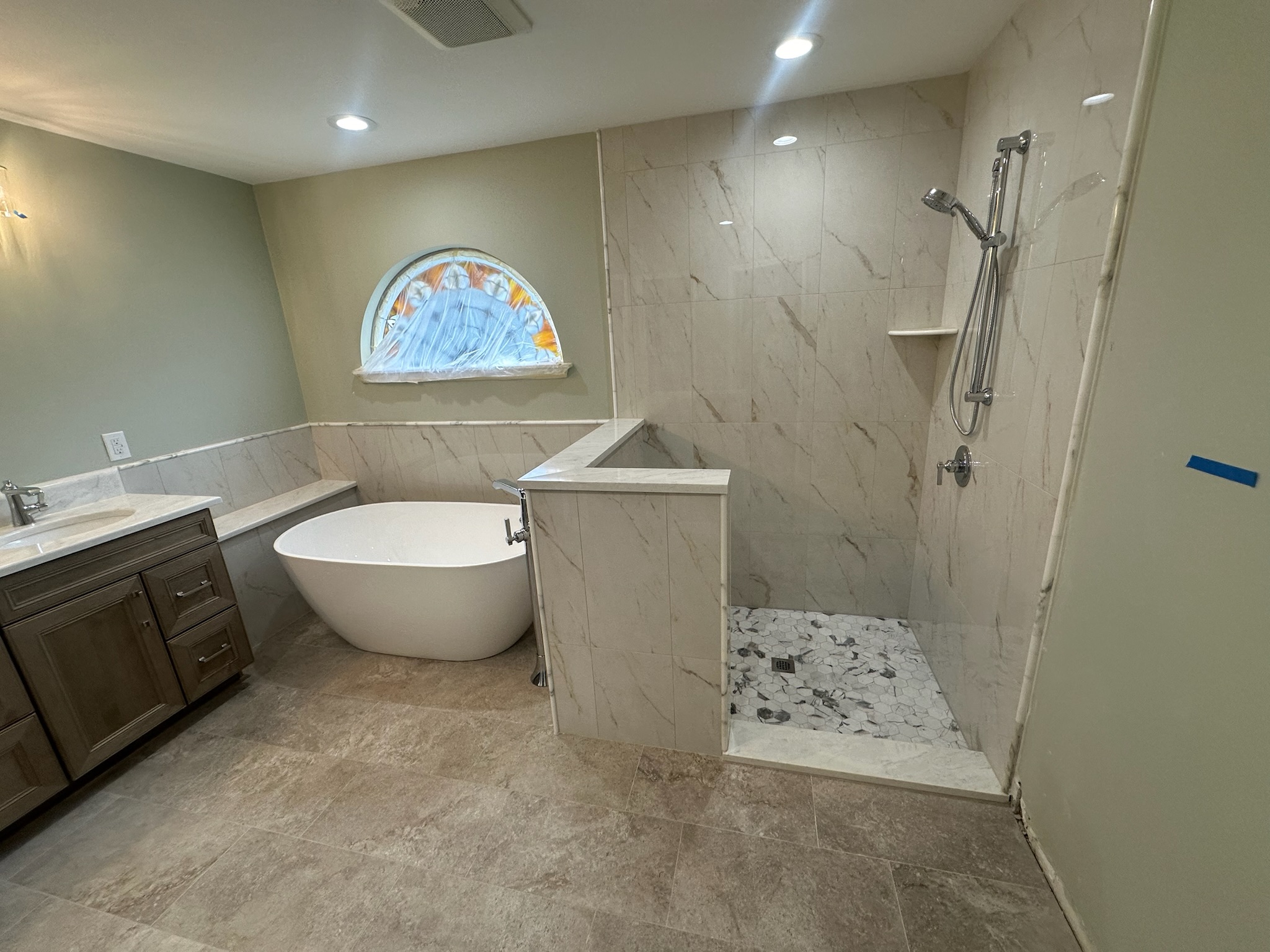 Freestanding Tub and Gray Mosaic Walk-In Shower.