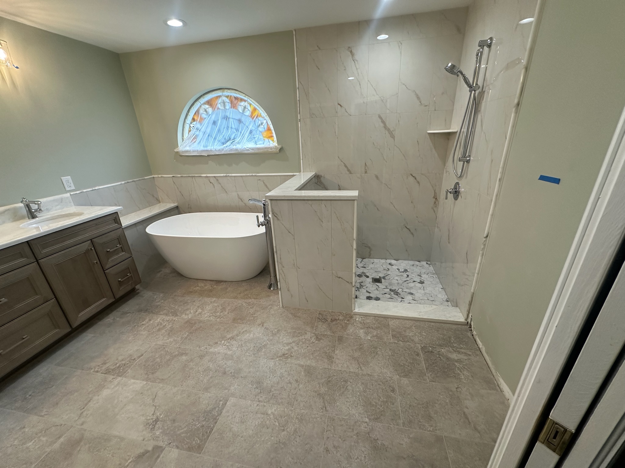 Freestanding Tub and Gray Mosaic Walk-In Shower.