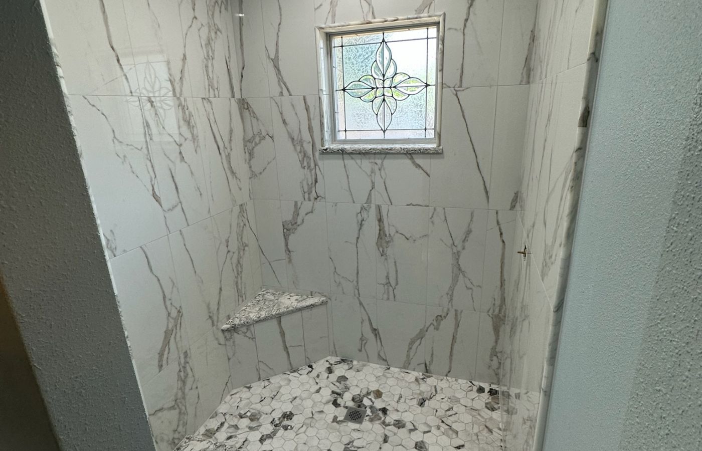 Marble Shower with a Bright Window.