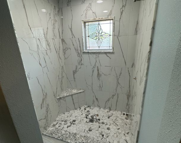 Marble Shower with a Bright Window.