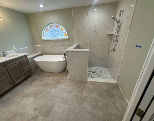 Freestanding Tub and Gray Mosaic Walk-In Shower.