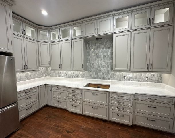 Gray Kitchen Cabinets with a Mosaic Tile Backsplash.